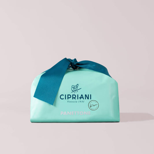Cipriani panettone packaging with a blue ribbon on a light gray background